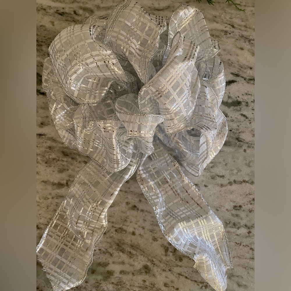 Large silver holiday Christmas bow